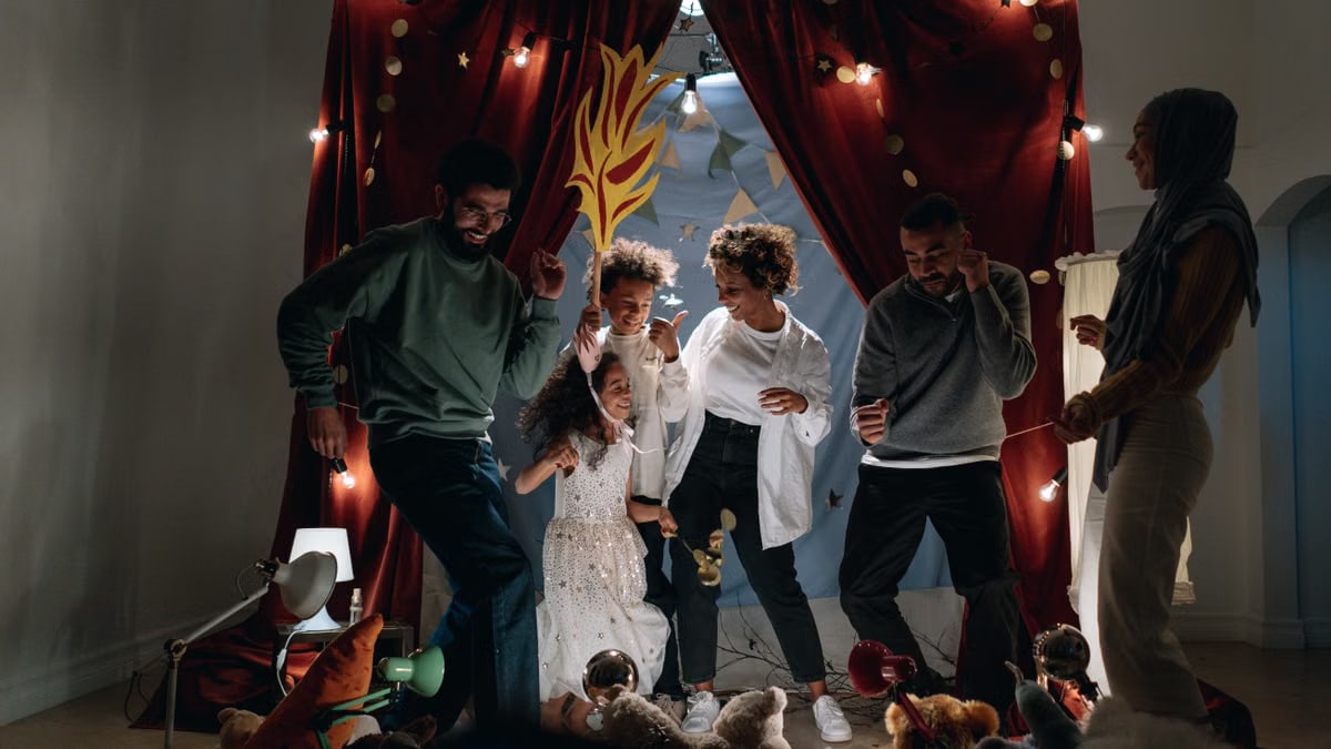 A joyful family bonding session with children performing indoors under fairy lights.